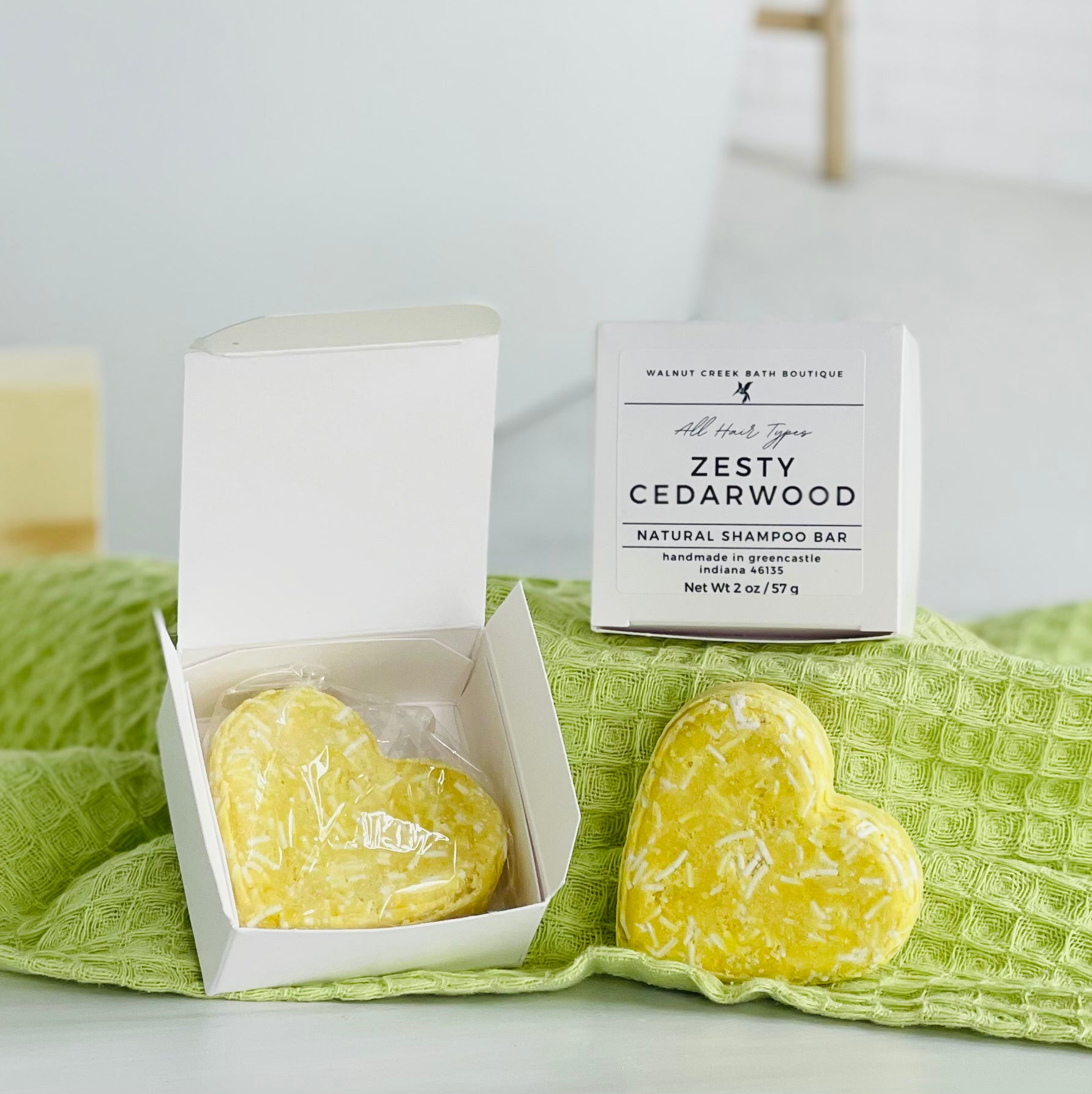 A natural shampoo bar with a yellow appearance, packaged in a white box with the product name &