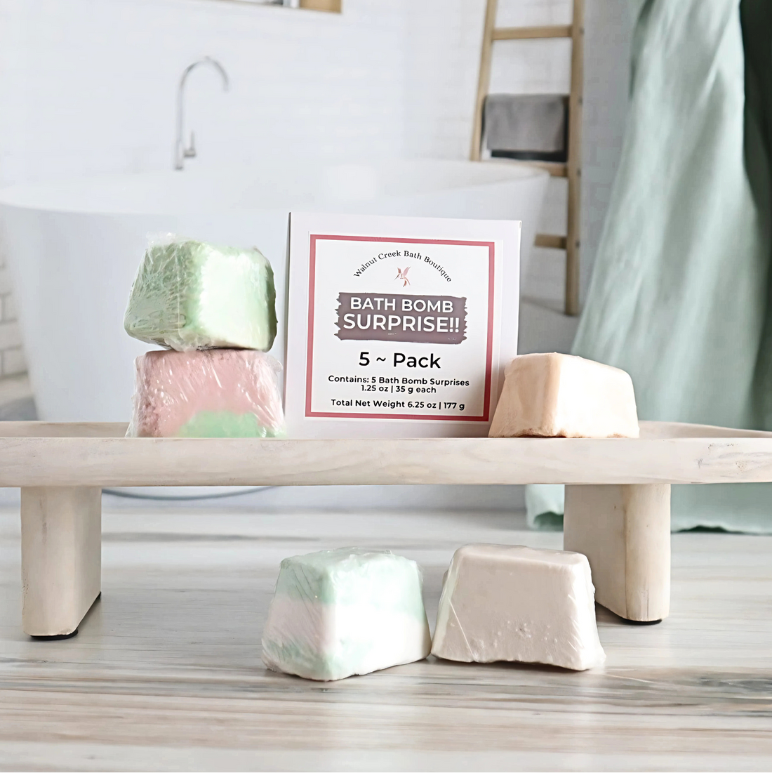 A 5-pack box of bath bombs for kids displayed on a wooden stand with a bath environment in the background, including a visible animal-shaped bath bomb.