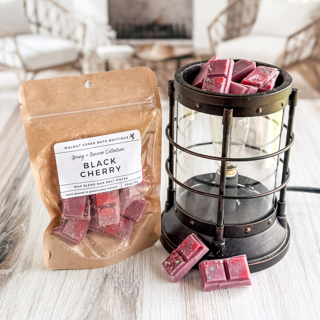 Packaged wax melts with a lantern and wax melts on a wooden surface.