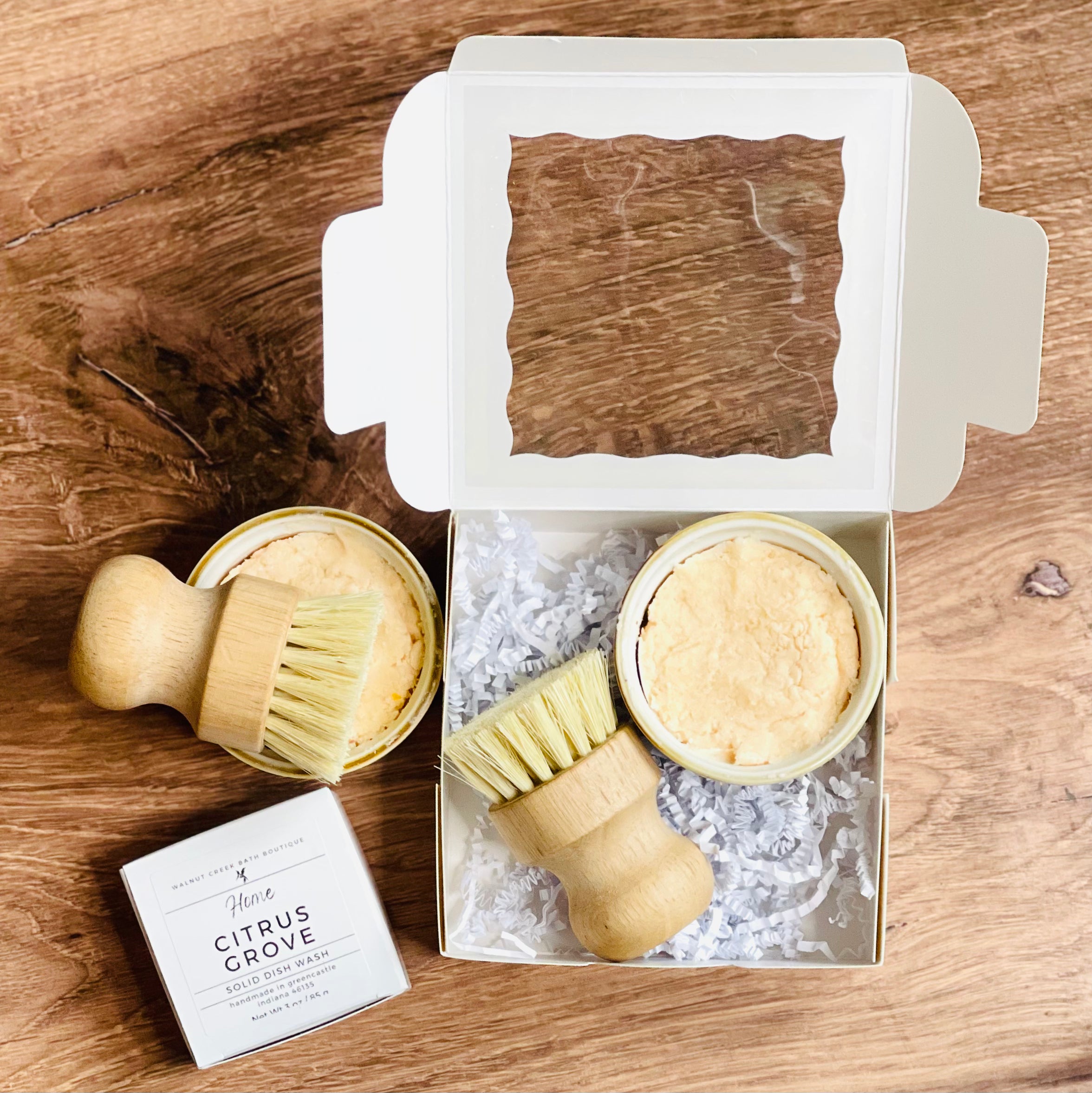 our citrus grove dish was is packaged in a box that holds both the crock and the brush. a little shred keeps everything in place while also adding a touch of fun.