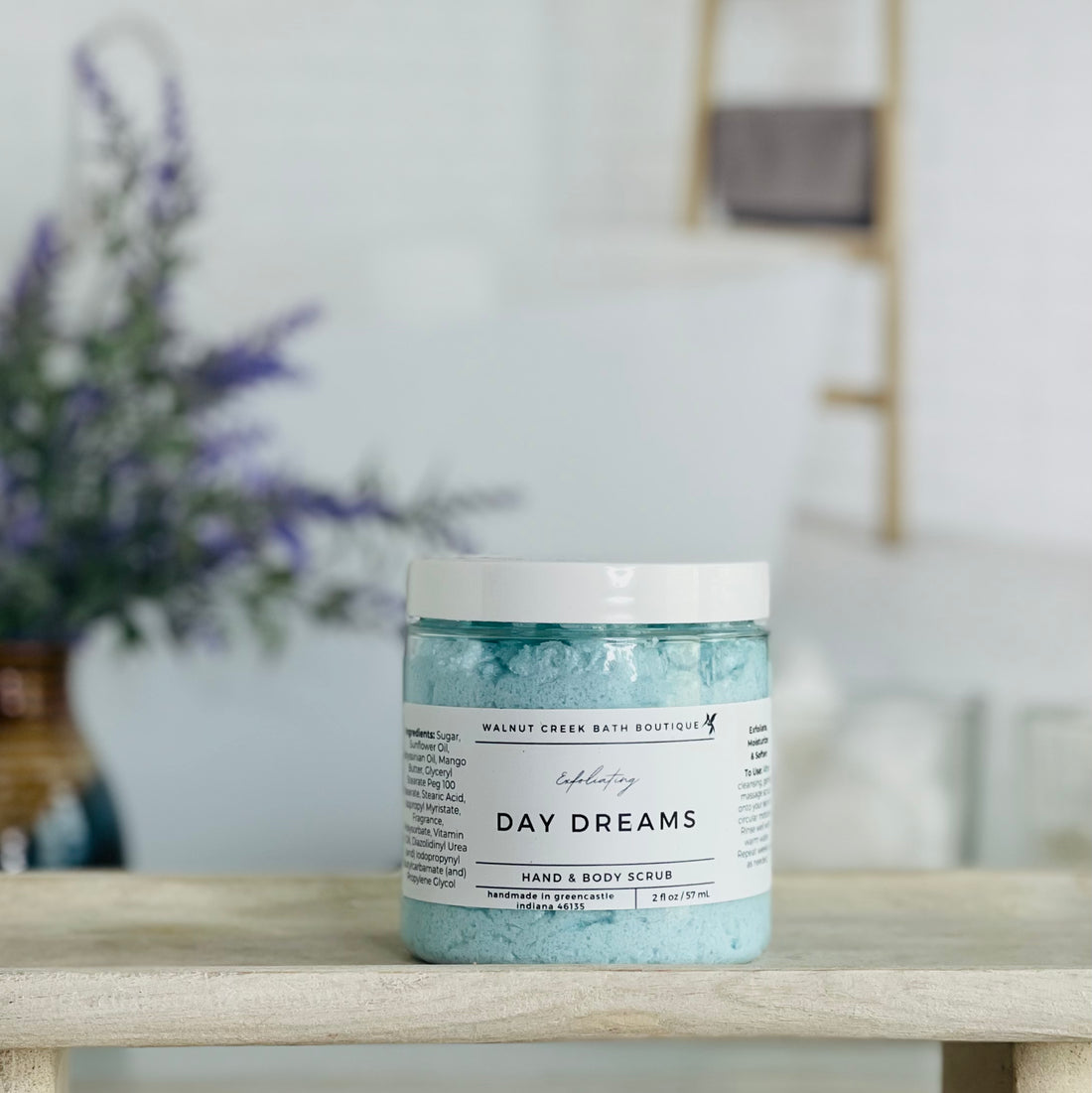 day dreams scrub is shown on a tray. there is some lavender in the background to give interest to this very calm and neutral image to evoke a peaceful experience.