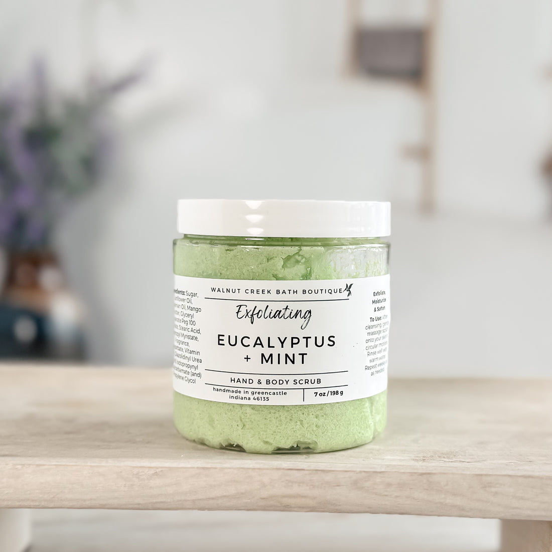 green eucalyptus and mint sugar scrub on wooden tray