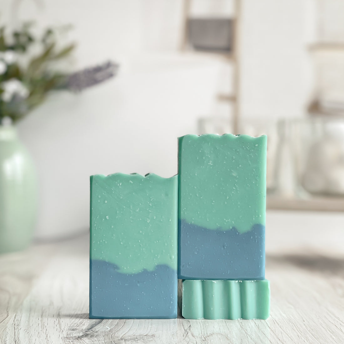 2 toned soaps, bottom is blue and top is green, one is shown laying flat to show the interesting top