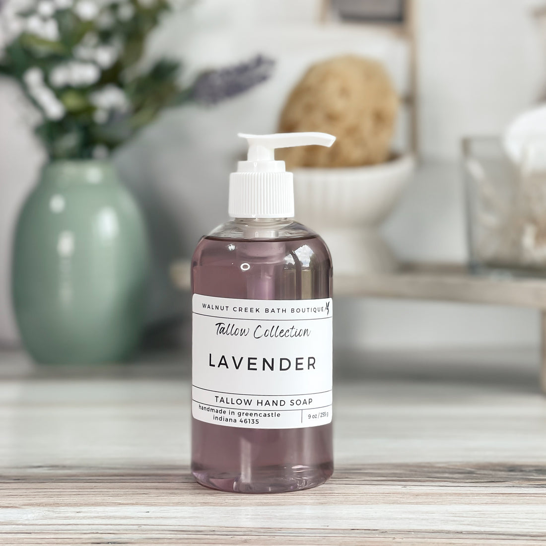 lavender tallow soap shown with white pump top.