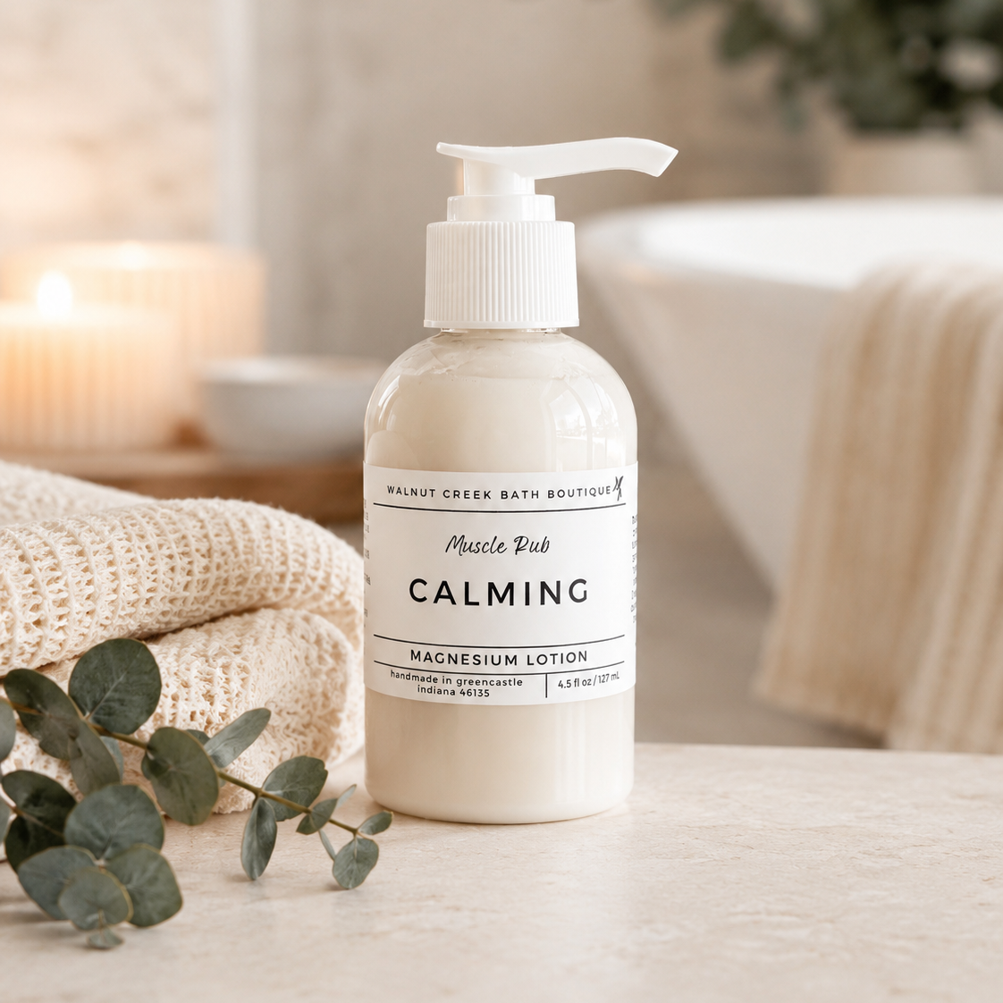 Calming magnesium lotion bottle on a bathroom counter with eucalyptus leaves.