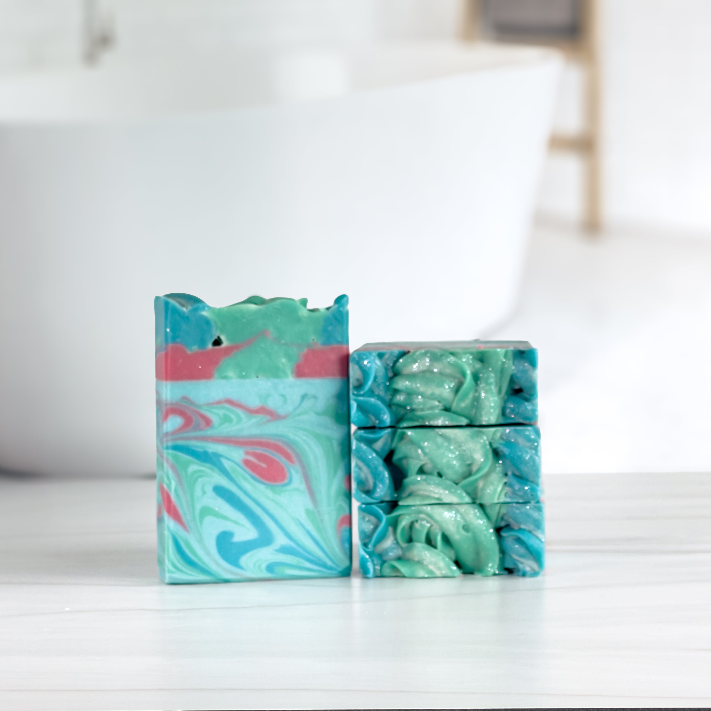 one mermaid dreams soap is standing next to three more laying flat to show the tops