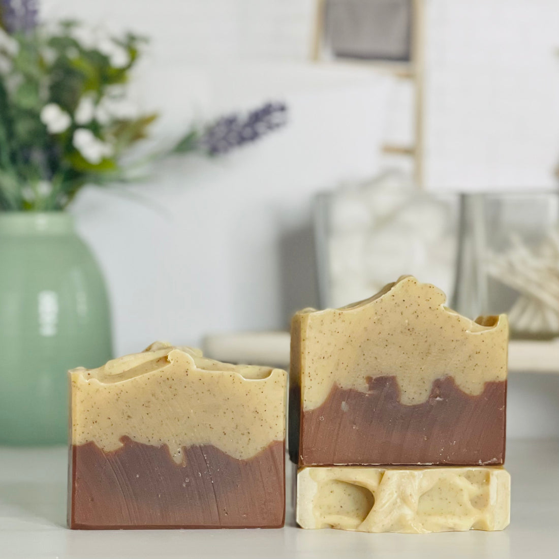 one mountain man soap is standing next to one laying flat to show the top and another standing on the flat one to show more of the soap colors