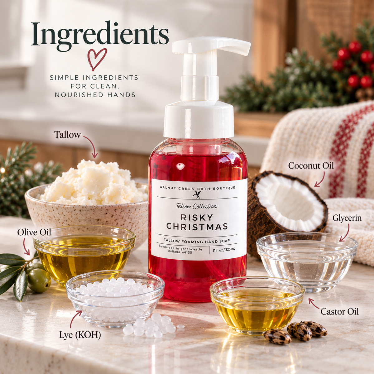 A bottle of Tallow Collection Risky Christmas Tallow Foaming Hand Soap stands on a marble surface with ingredient bowls and labels around it, including tallow, coconut oil, olive oil, glycerin, castor oil, and lye (KOH). The scene is styled with holiday greenery and a knitted blanket in the background.