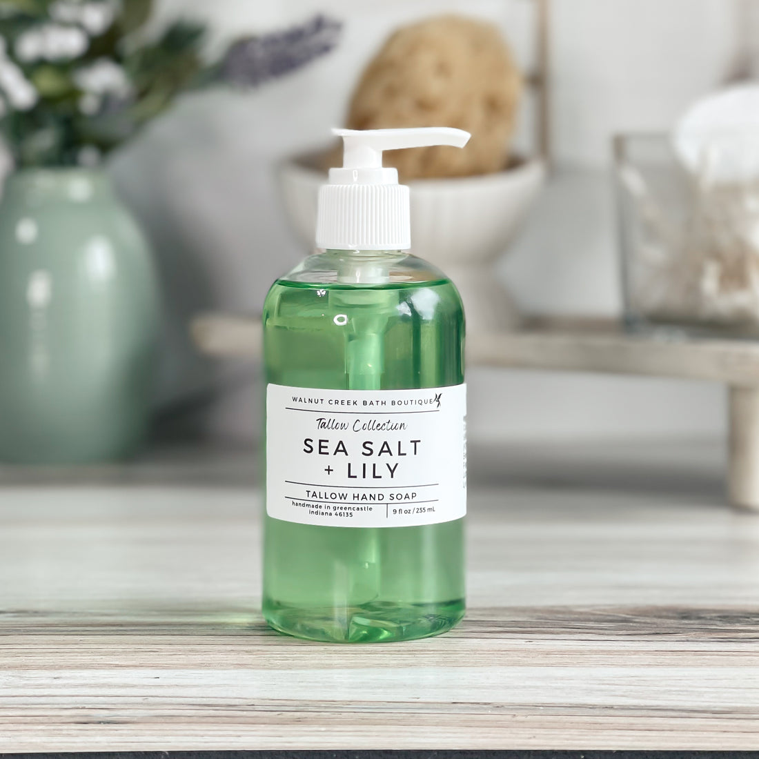sea salt and lily soap showing the pretty green color of the soap with a white pump top