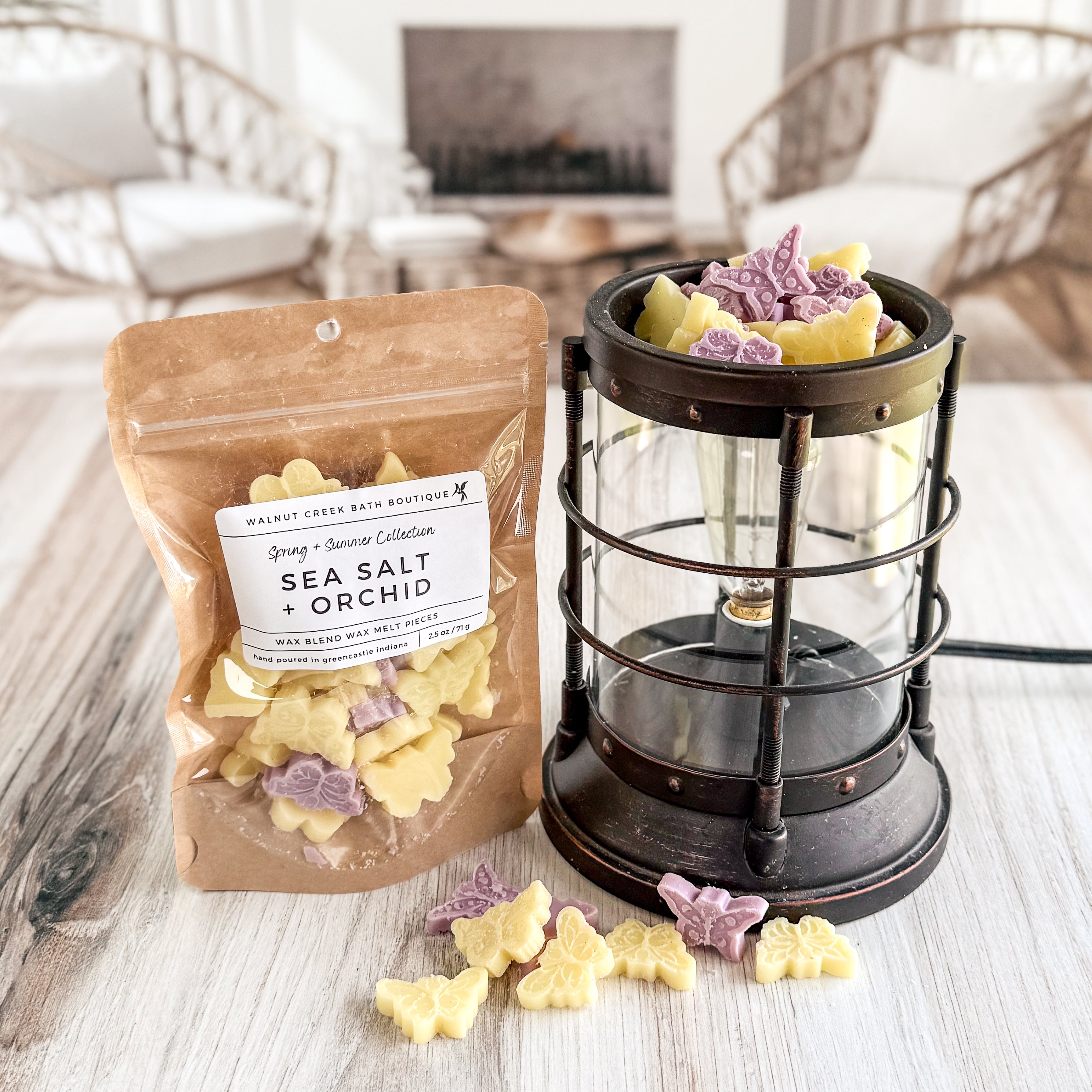 purple and yellow butterfly wax melt pieces next to melter