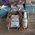 soap of the month club open box showing apple cider and oak soap and room spray nestled in a box with shred. There are other closed boxes in the background waiting for shipment