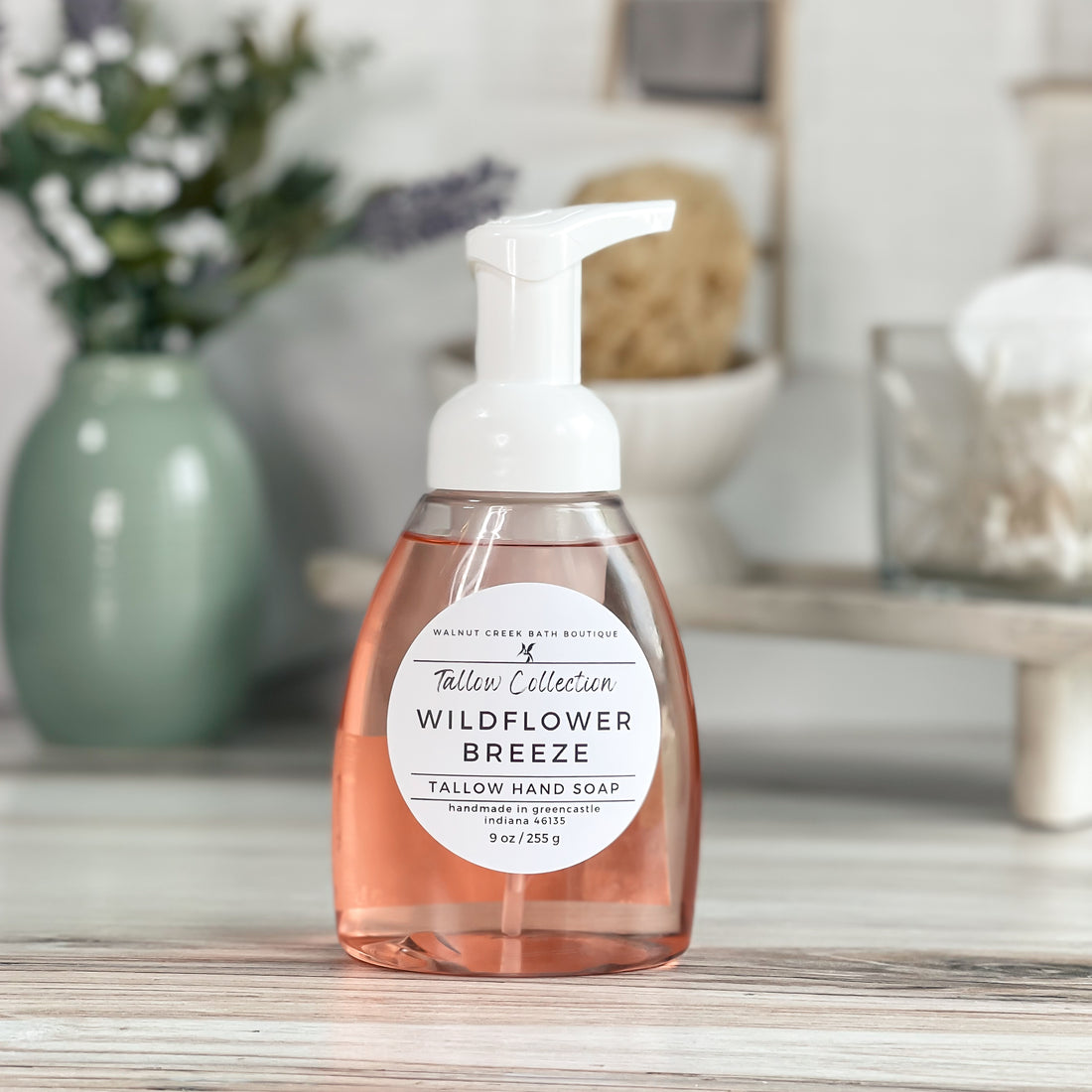 wildflower breeze soap in a foaming pump bottle. the color of the soap is a very light peachy color