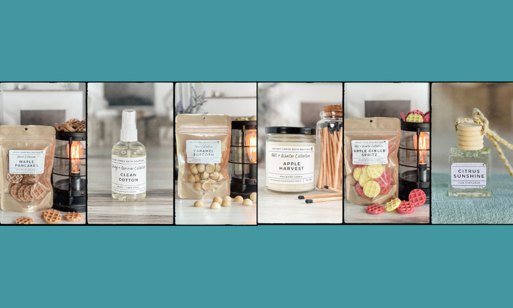 A lit candle surrounded by Hand Poured Wax Melts and candles along with a few bottles of room and linen sprays