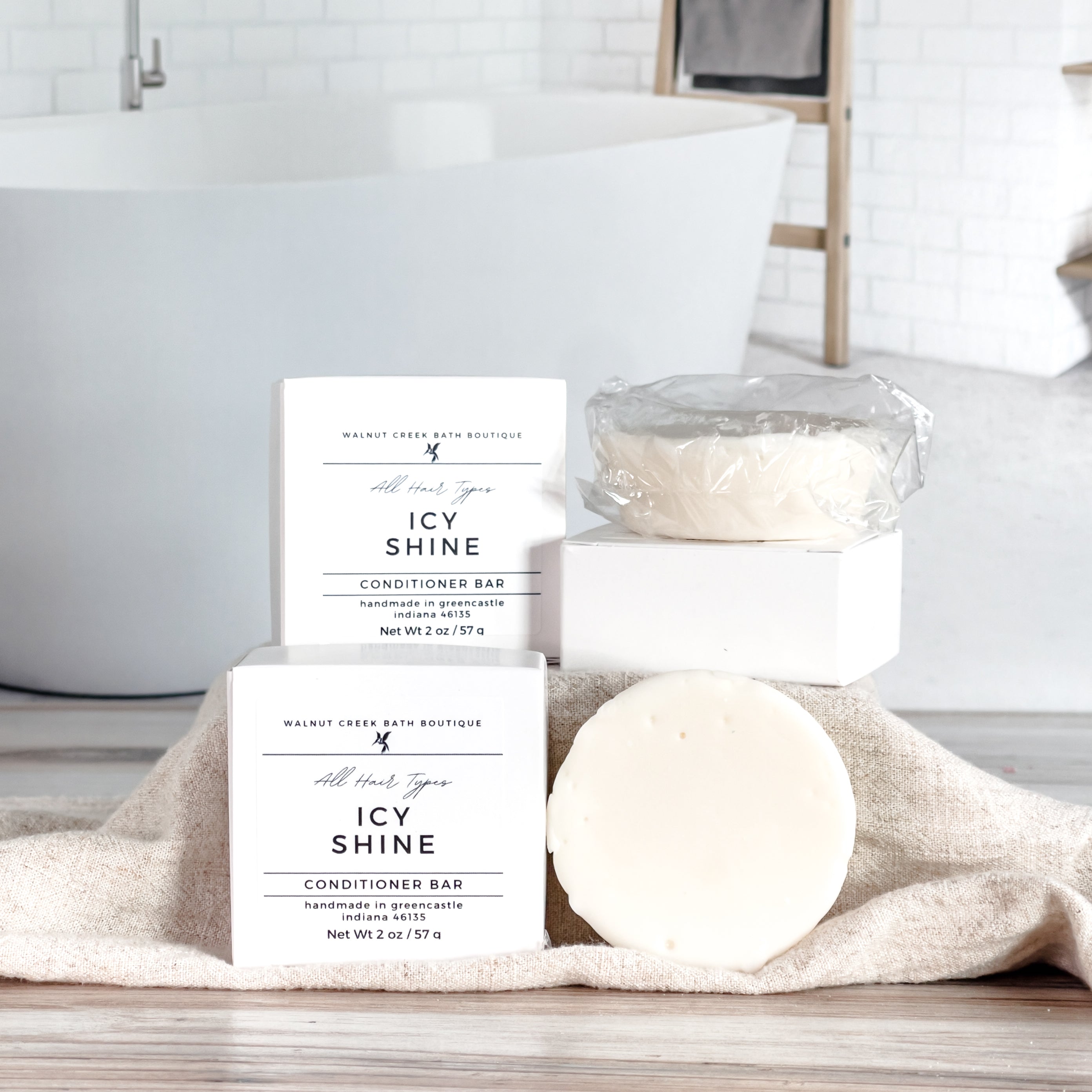 boxes of icy shine conditioner bars, along with an open bar to show creamy texture - some bars are lifted on a riser 