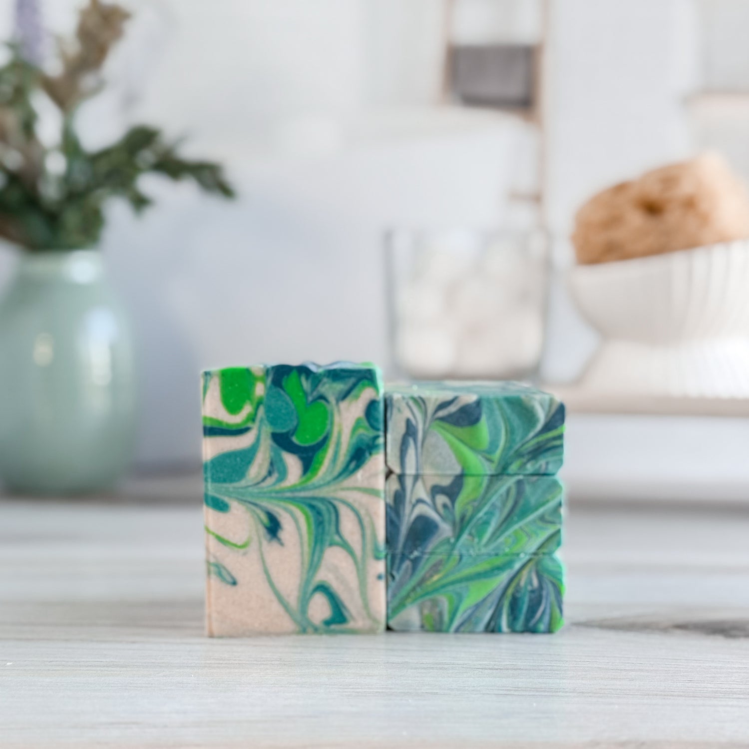 Three marbled soap bars on a surface with a blurred background