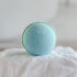 Blue bath bomb on a white fabric background