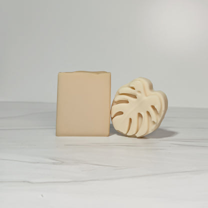 Two beige soap bars on a light gray background