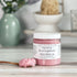 blackberry and magnolia scrub with a spoonful of scrub on the table next to it