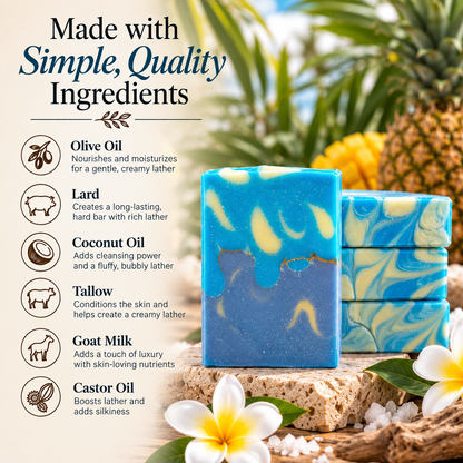 Two handmade blue and yellow marbled soap bars displayed on a rustic wooden surface with tropical flowers and pineapples in the background. The left side features text detailing the ingredients: olive oil, lard, coconut oil, tallow, goat milk, and castor oil.