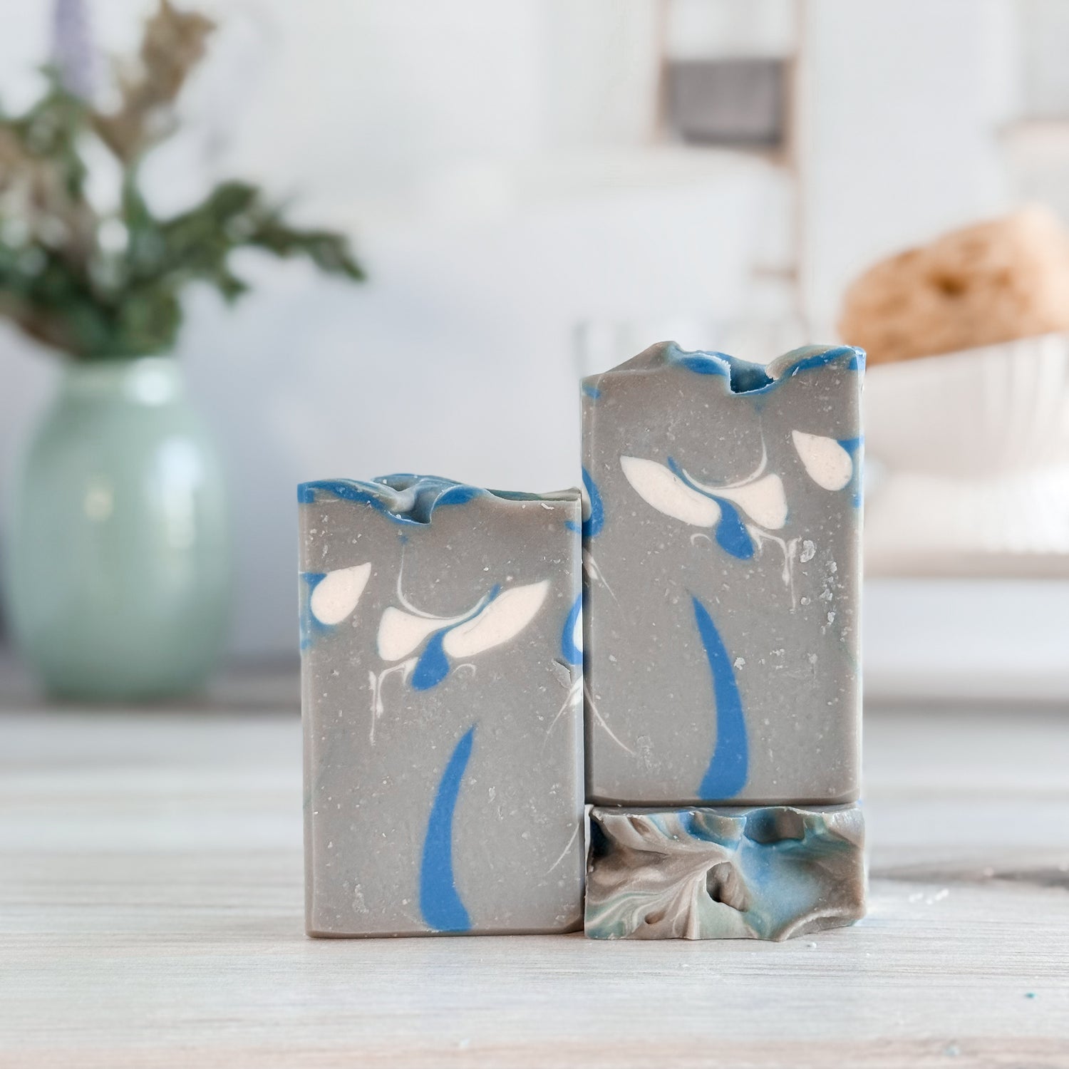 Two decorative vases with a floral pattern on a wooden surface.