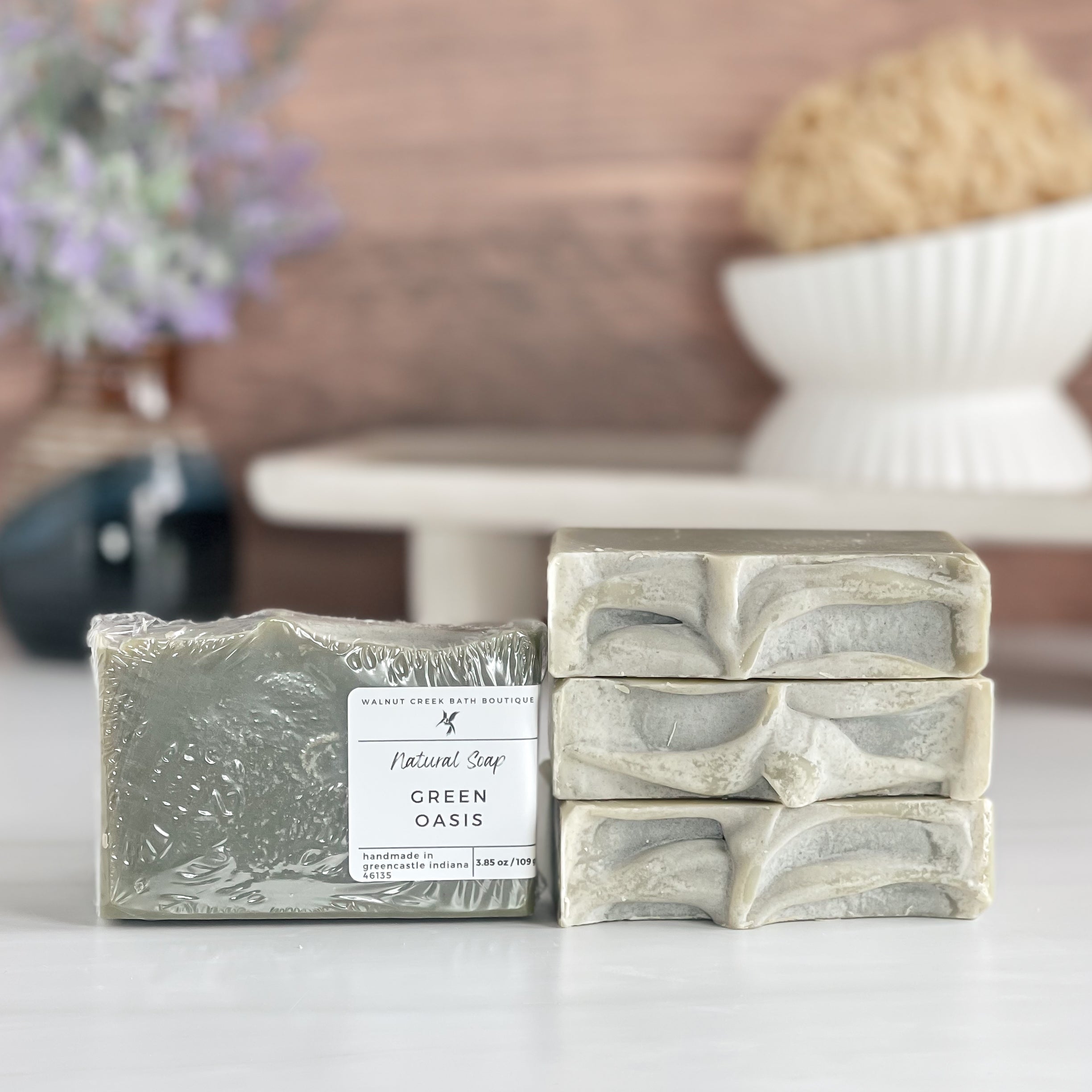 a green oasis soap is standing tall packaged in it&