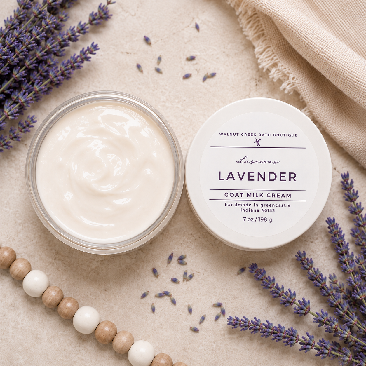 Goat milk cream jar with lavender flowers and a label on a textured surface