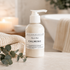 Calming magnesium lotion bottle on a bathroom counter with eucalyptus leaves.