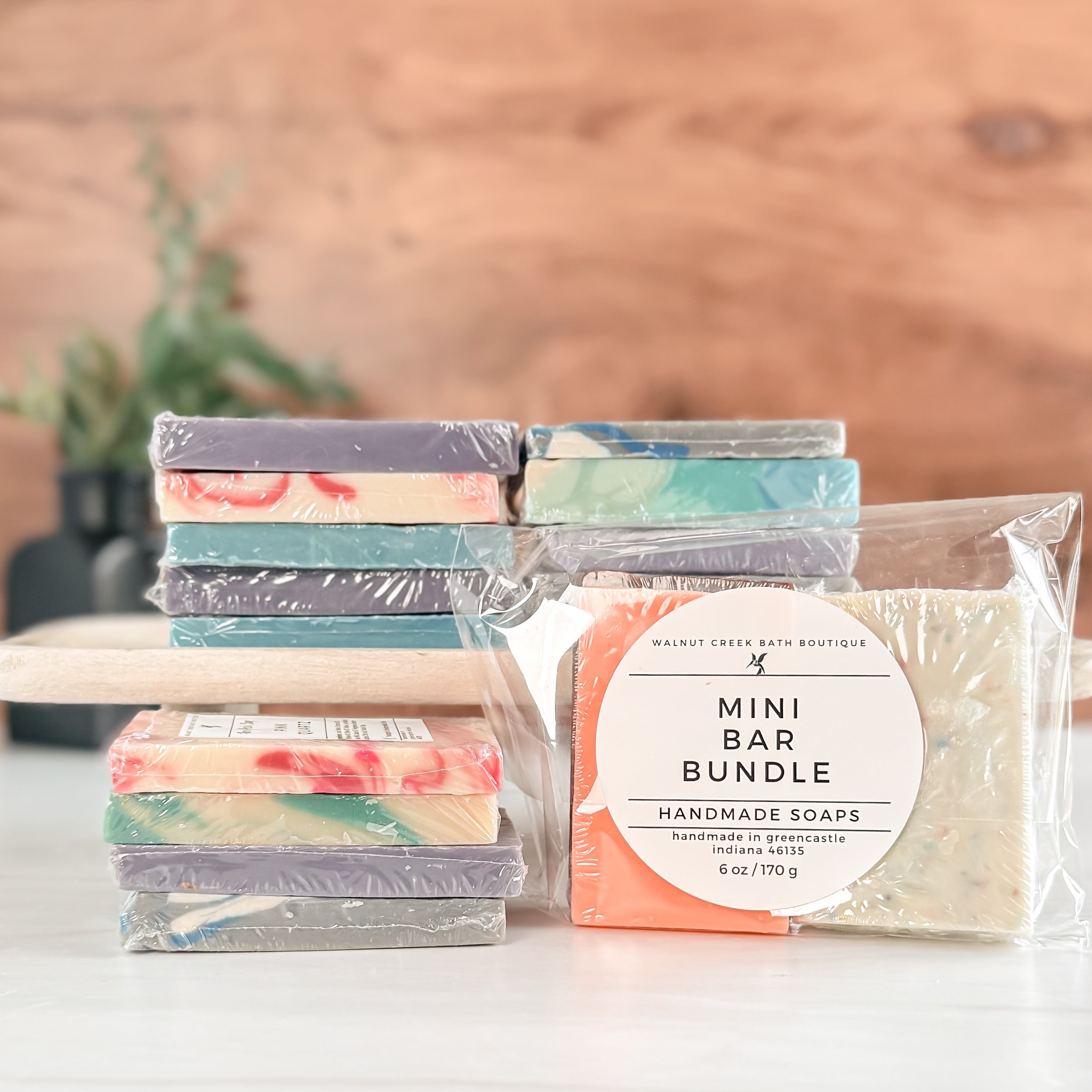 Packaged mini soap bars with a visible label on a wooden surface