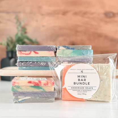 Packaged mini soap bars with a visible label on a wooden surface