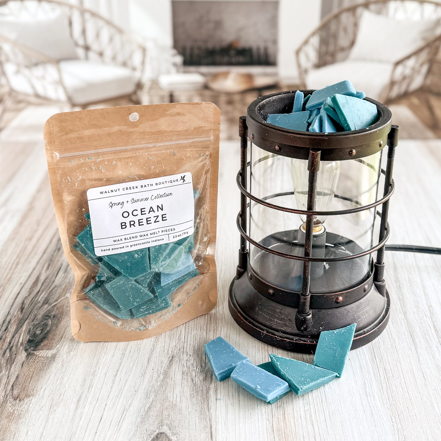 Ocean Breeze wax melts in packaging with a lantern on a wooden surface.