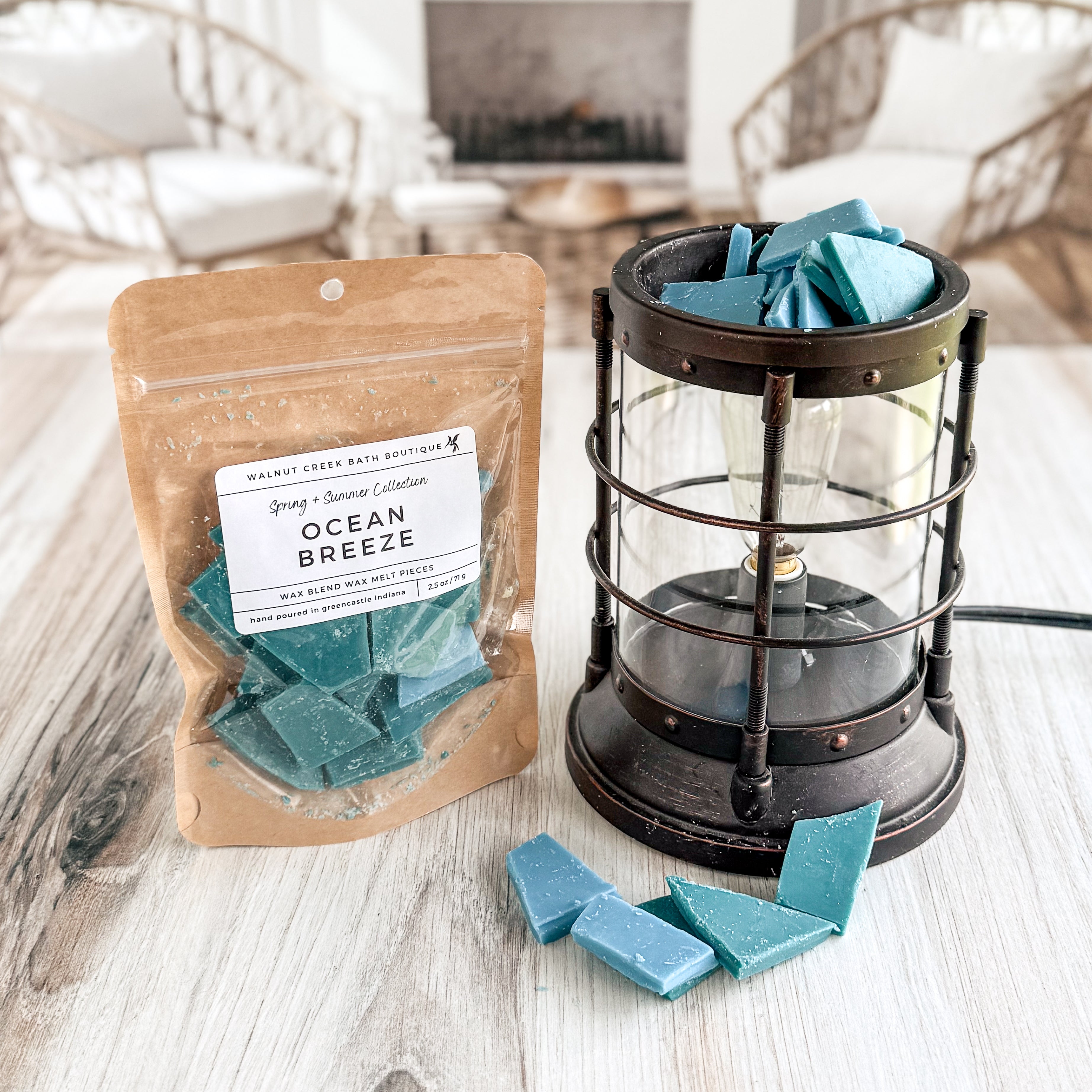 Ocean Breeze wax melts in packaging with a lantern on a wooden surface.