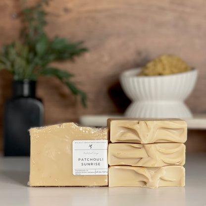 a patchouli sunrise soap is standing tall packaged in it&