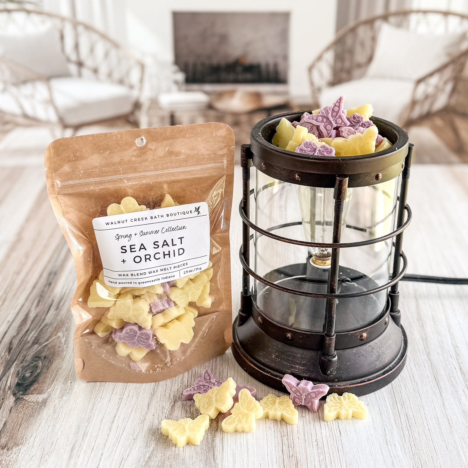 purple and yellow butterfly wax melt pieces next to melter