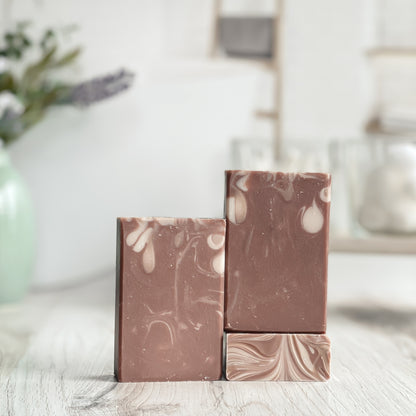 Marbled brown and beige soap bars on a light surface with a blurred background