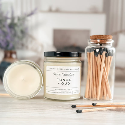 Candle with matches and a jar of matches on a surface