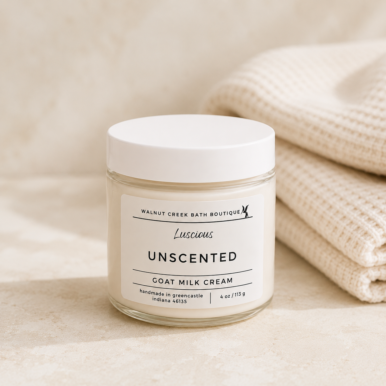 Jar of unscented goat milk cream with a label on a beige background