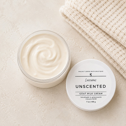 Unscented goat milk cream jar with lid on a beige surface