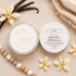 Jar of Velvet Vanilla cream with vanilla beans and flowers on a beige background