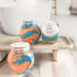 Two jars of bath bomb dust labeled &
